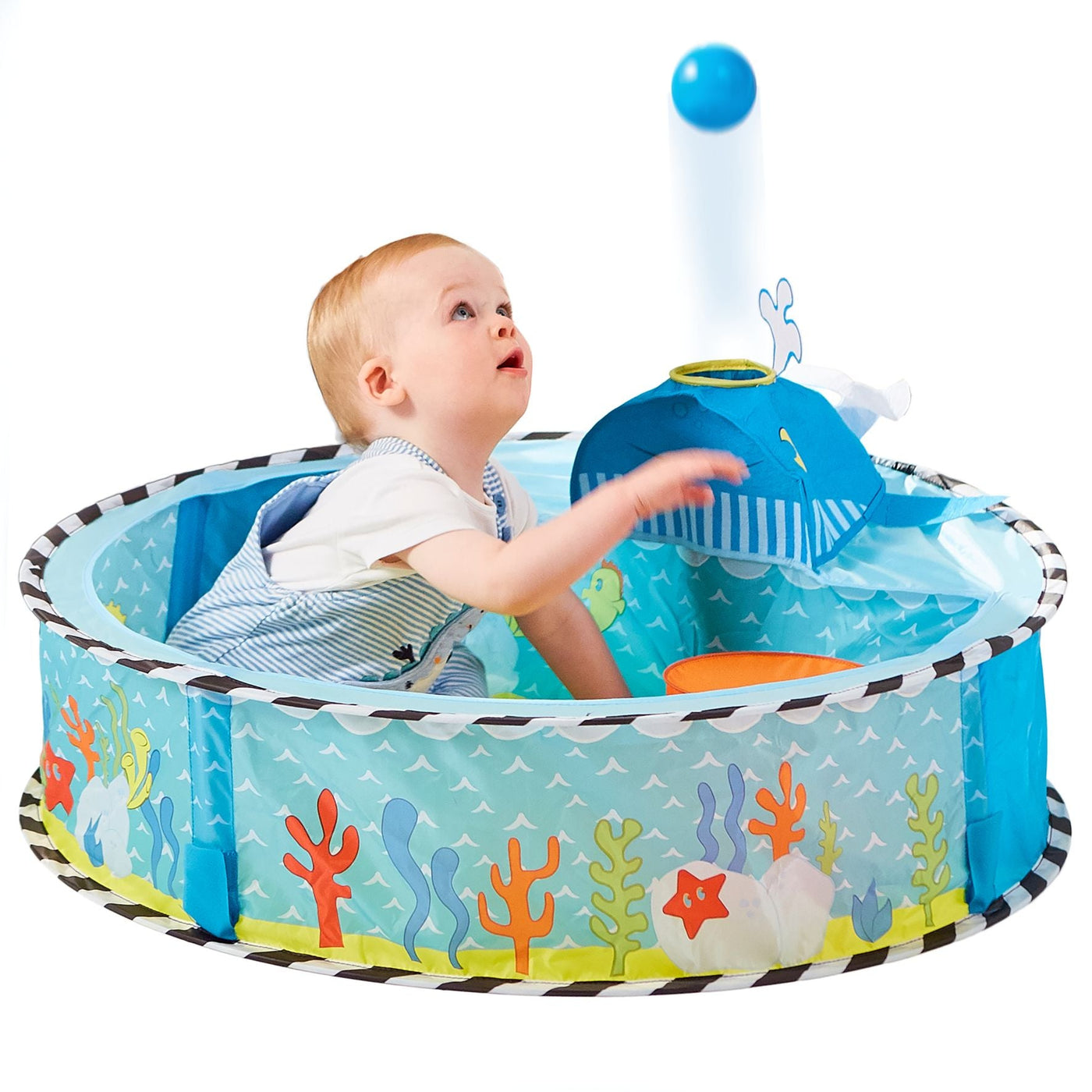 Baby plays in undersea-themed ball pit with whale ball launcher, enhancing hand-eye coordination and sensory development.