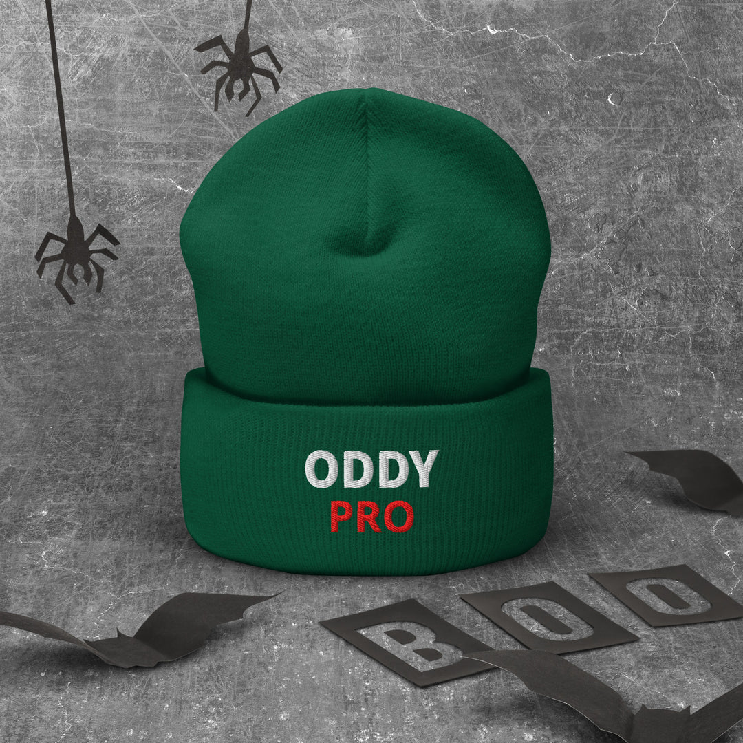 Oddy Pro Cuffed Beanie displayed on a textured background, featuring a snug green design with embroidered text.