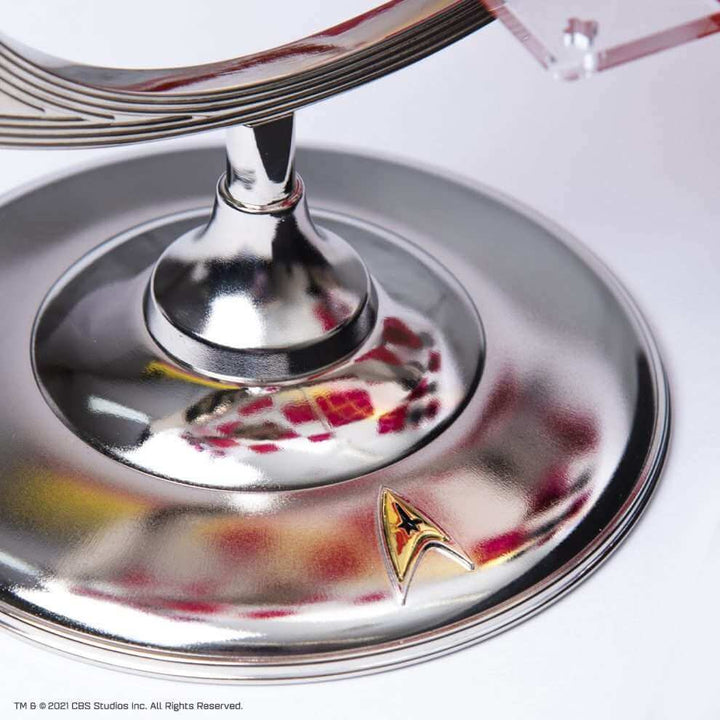 Close-up of the base of the Star Trek Tri-Dimensional Chess Set, showcasing the shiny zinc alloy and Starship emblem.