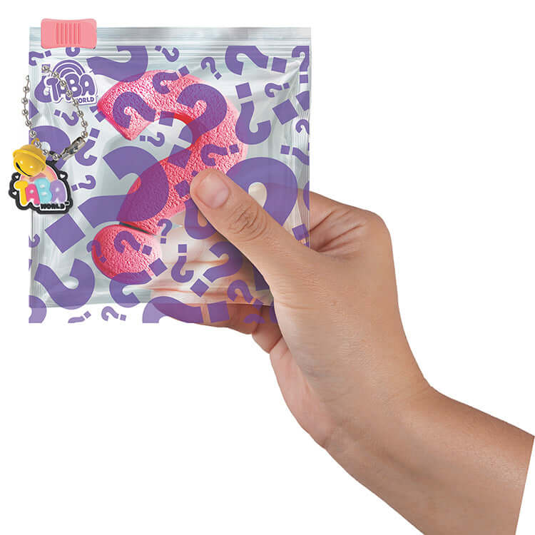 Hand holding a Taba World Ready-Made Mystery Tabas 4 Pack with a question mark design on the pouch.