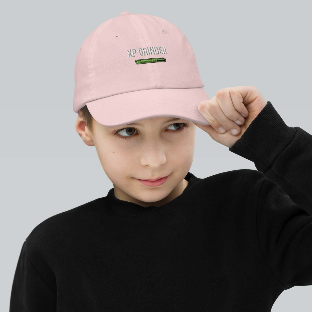 XP Grinder Youth baseball cap worn by a young boy in a pink color, perfect for baseball training and outdoor activities.