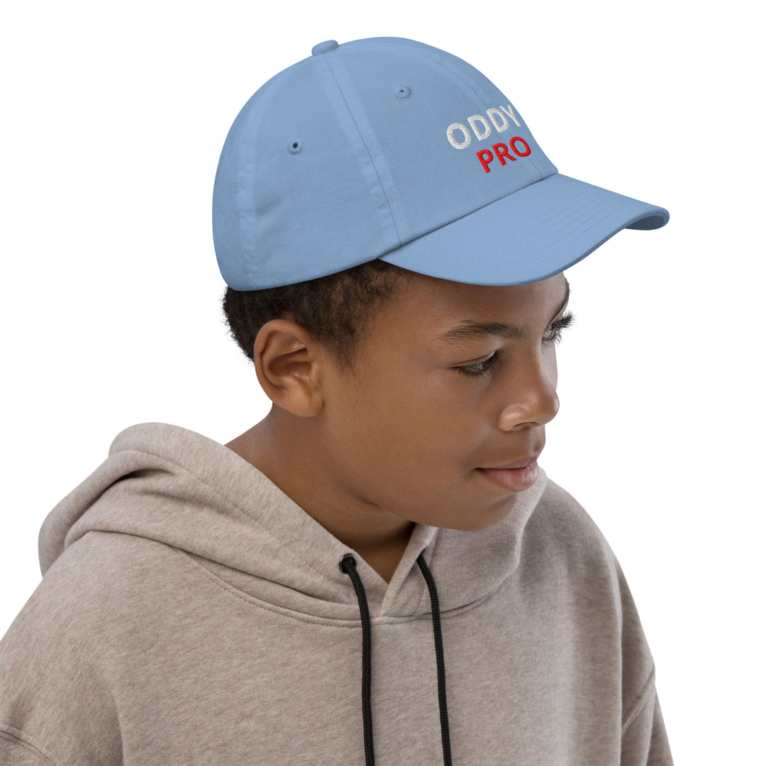 Oddy Pro Youth baseball cap in blue worn by a child, providing style and sun protection during outdoor activities.