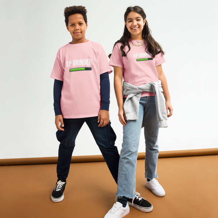 Two kids wearing the XP Grinder Youth classic tee in pink with stylish outfits and a casual backdrop.