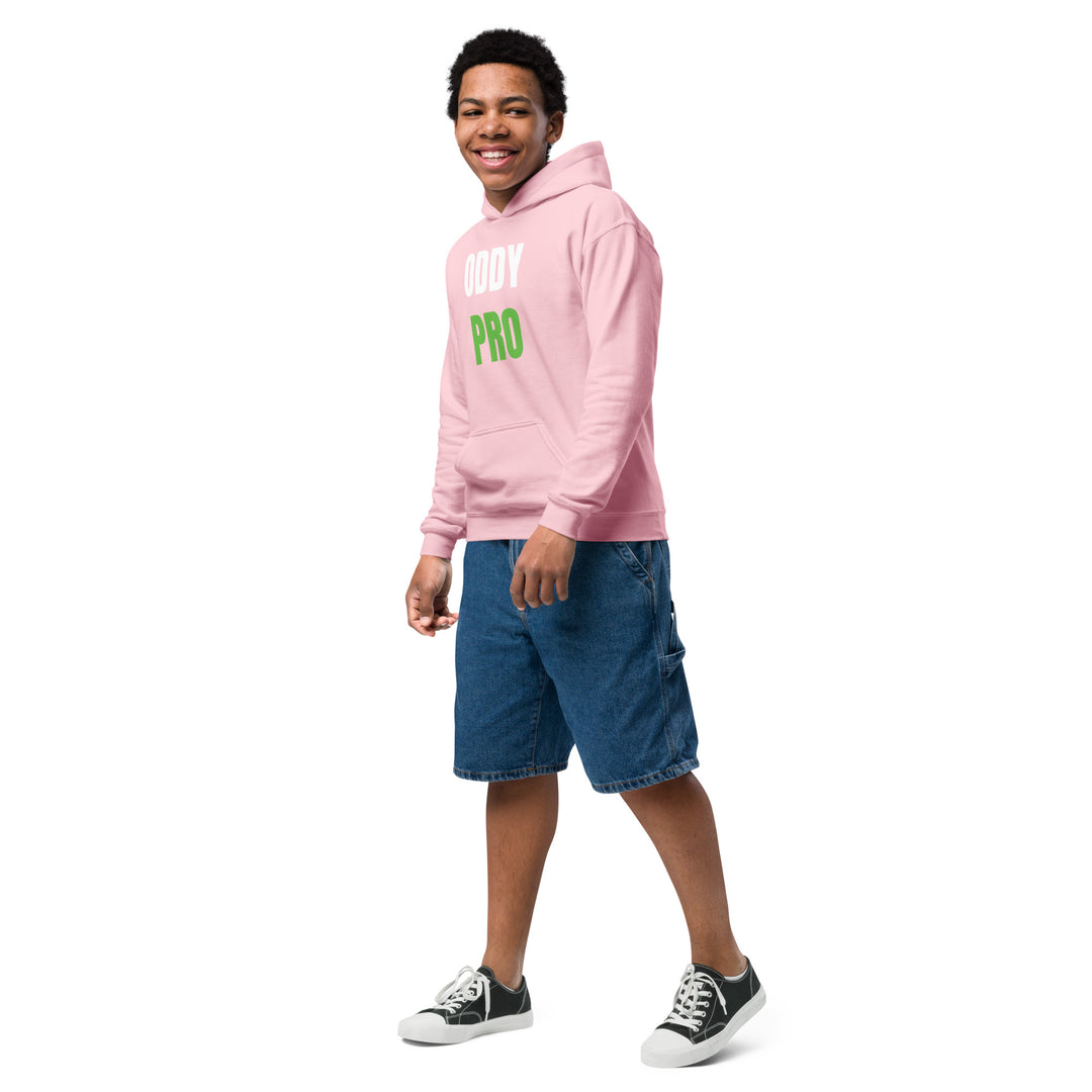 Young boy wearing an Oddy Pro Youth heavy blend hoodie in pink, paired with denim shorts.